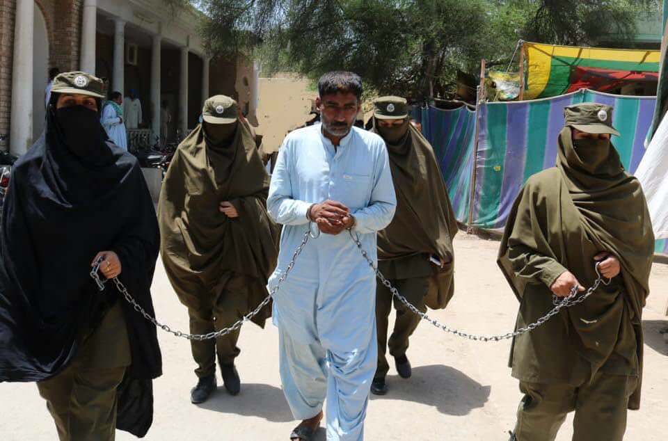Female Pakistani Police officers escort a man to jail for abusing his daughter.  The judge made sure the last people he saw outside of jail were women.