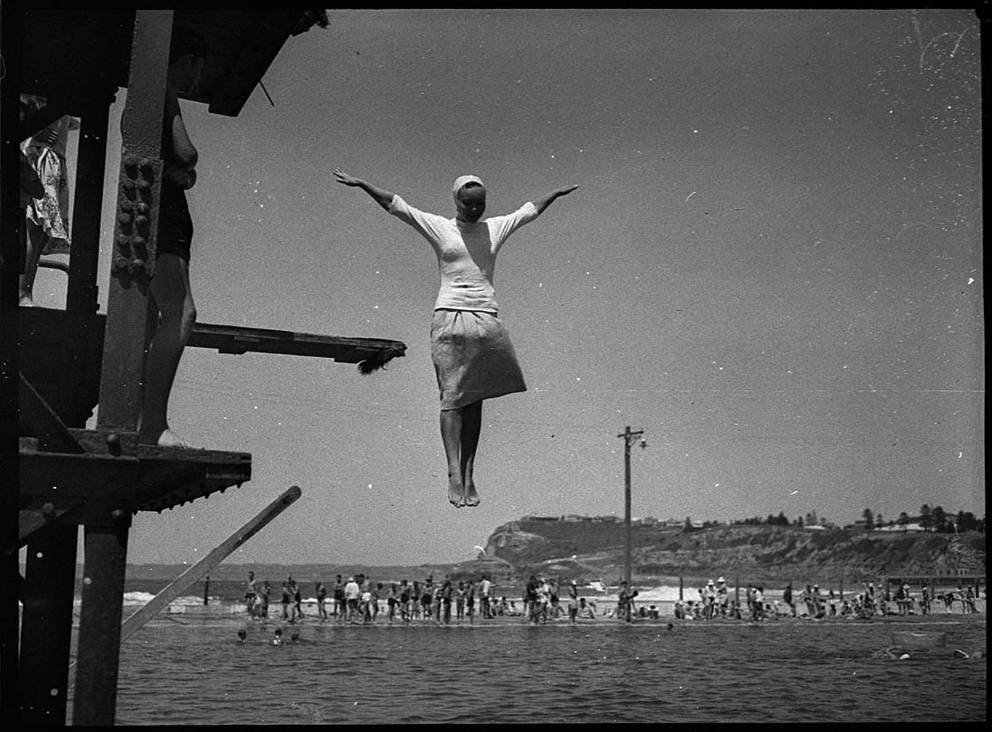 A woman jumps in the water in Newcastle, Australia in 1937.