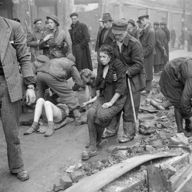 Russian men and women who were forced to do slave labor being helped after their German captors had forced them in a cellar and set the building on fire in 1945. Luckily the fire was put out in time.