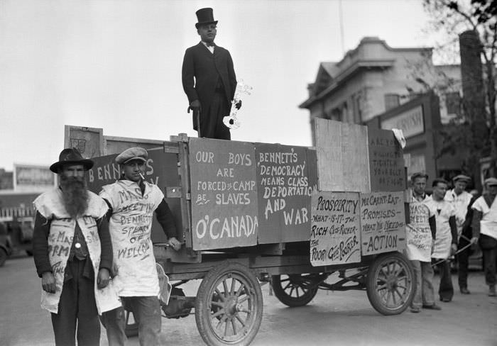 A political wagon and their supporters with signs and shirts against politician R. B. Bennett in Montreal, Canada in 1938.