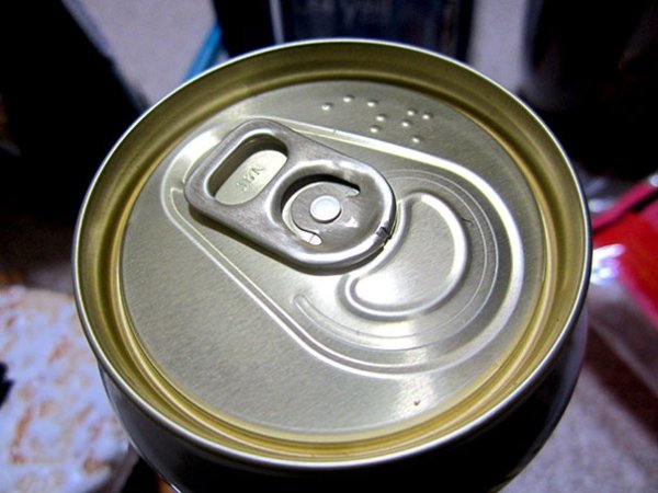 Drink cans have names written in braille on the top.