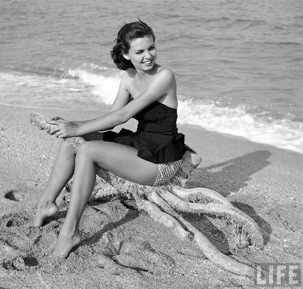 A model sort of riding a thick dead sea plant in the US in 1955.