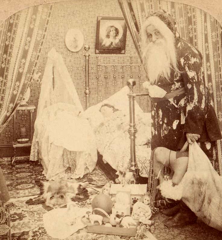 A man dressed as Santa Claus looks over a sleeping girl in the US in 1901.