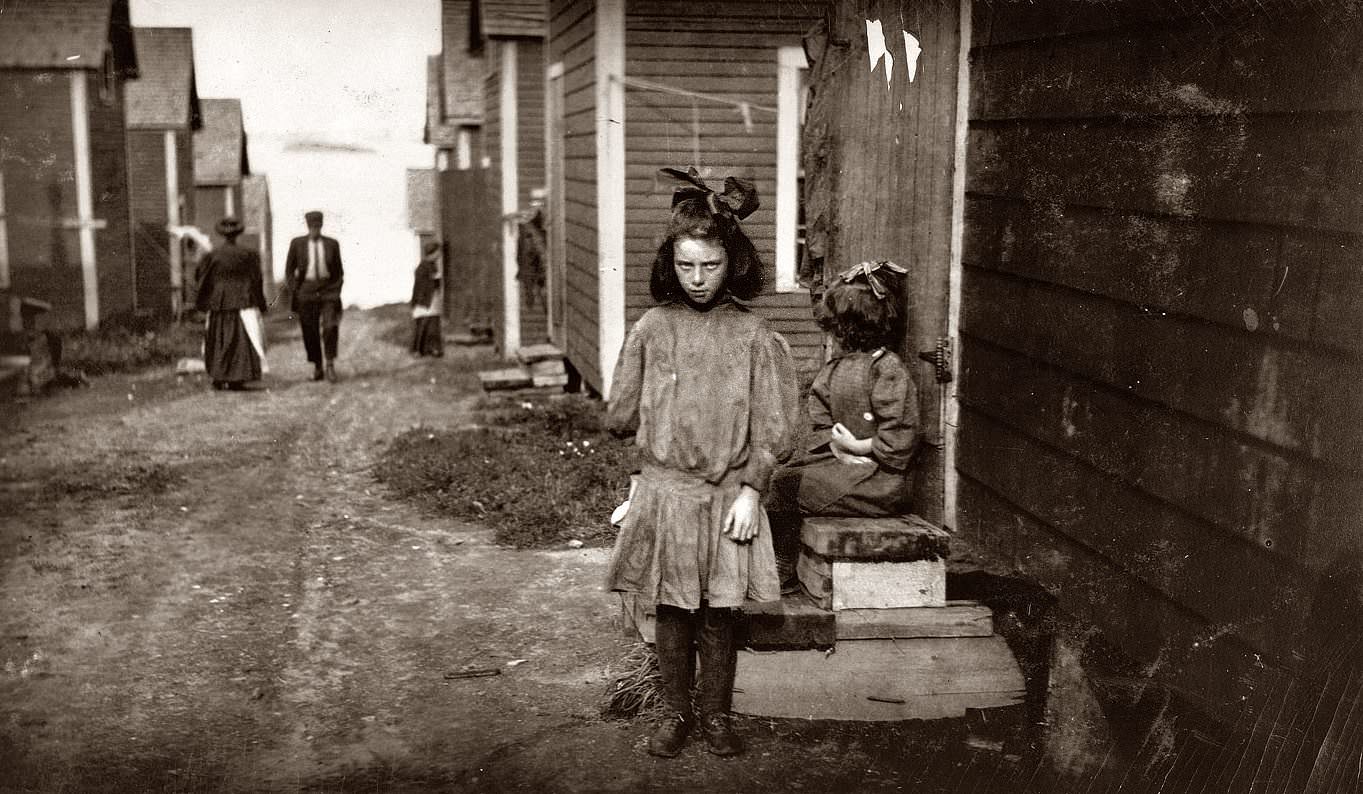 A child stares down the camera man in a mining town in the US in 1911.