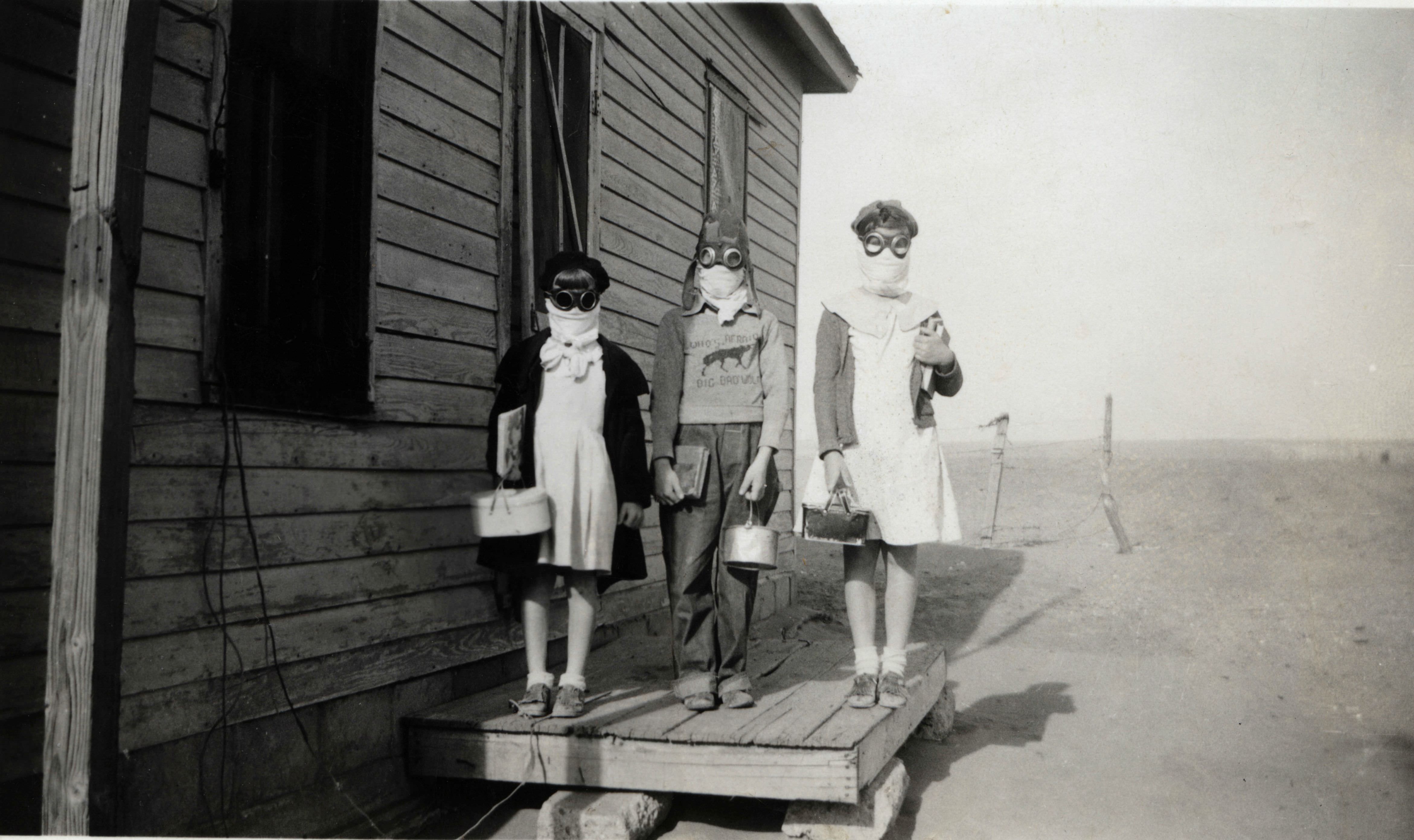 3 Children on their way to school in Oklahoma, US in 1933. This was during the terrible time know as The Dust Bowl, when storms ravaged the area in the 1930s. The storms were saw bad, people could not venture outside without wearing protection. This also heavily affected farming and gave people health issues as well, with some cases causing deaths. Severe drought and a failure to apply dryland farming methods know as the Aeolian process which would prevent wind erosion caused the phenomenon. The key areas affected were parts of Oklahoma, Texas, New Mexico, Colorado and half of Kansas. Poor families in particular had to abandon their homes and land entirely, as they couldn't grow anything and could not pay their mortgages. This was also during the Great Depression, leaving little other options for work in the affected areas. In the 1930s, it is estimated 3.5 million people moved out of the plain states, many to California.