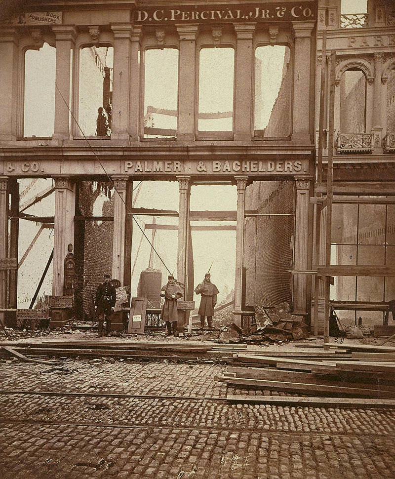 Soldiers on watch to prevent looting after the Great Boston Fire in 1872. The fire began in a commercial buildings basement. It moved incredibly fast, and it destroyed 776 buildings over 65 acres in just 12 hours. Much of the financial district was burned to the ground, costing $73.5 million in damage (that's $1.5 billion today). The timing and fast action did prevent deaths, as only 13 people died in the blaze, but no city authority existed at the time to enforce building codes, meaning many of the buildings were old and prone to fire. As with many protection measures in the US, a major avoidable disaster has to take place before action is actually taken.