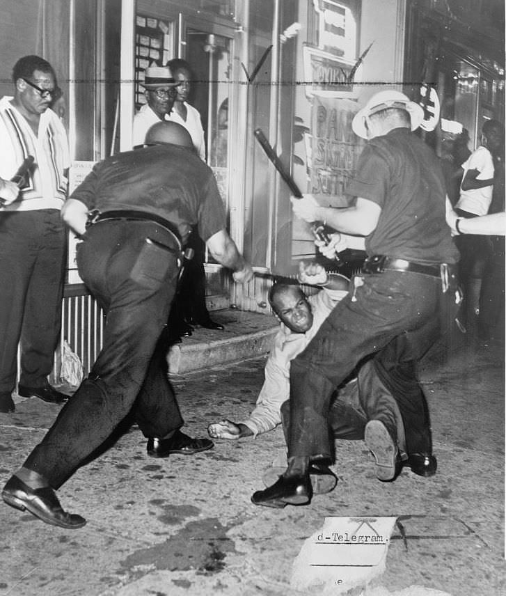 A protester is beaten during the beginning of the Harlem Riots in NYC, US in 1964. The riots began when a 15 year old unarmed black boy, James Powell, was gunned down by Lieutenant Gilligan in front of Powells friends and other witnesses. At first, 300 students protested, then the entire borough of Harlem started protesting. The police began pushing them back with beatings but had to retreat as the protesters turned to rioters. The riots went on for 6 straight nights, damaging much of Harlem itself. It was finally quelled. One rioter was killed, with 118 wounded and nearly 500 arrested. It was estimated some 4,000 partook in the riots. Unfortunately, as with most documented race riots in the US, almost all the damage accumulated affected businesses and homes owned by other black people.