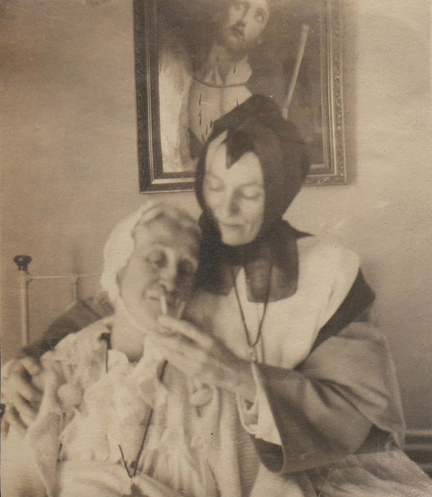 A nurse helps a patient with Jesus looking a little uncomfortable in Spain in 1934.