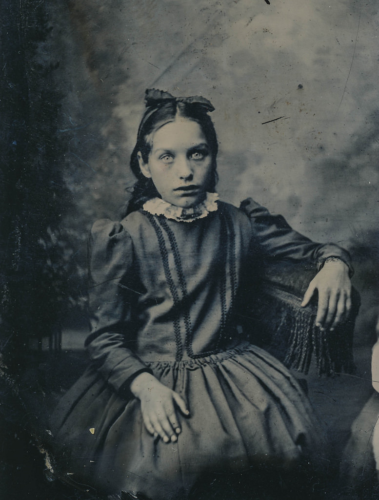 A portrait of a girl in England in 1892. Although rare, some portraits of dead family members shortly after dying exist from England at this time, but on a picture like this, hard to know if that is the case.