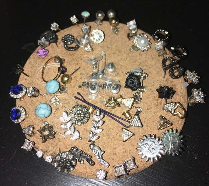 A cork coaster is the best organizer for your earrings.