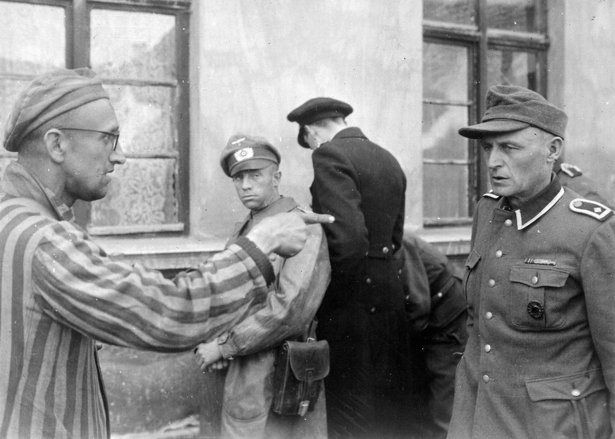 A Russian man confronts a guard after the liberation of the Buchenwald concentration camp in Thuringia, Germany in 1945.
