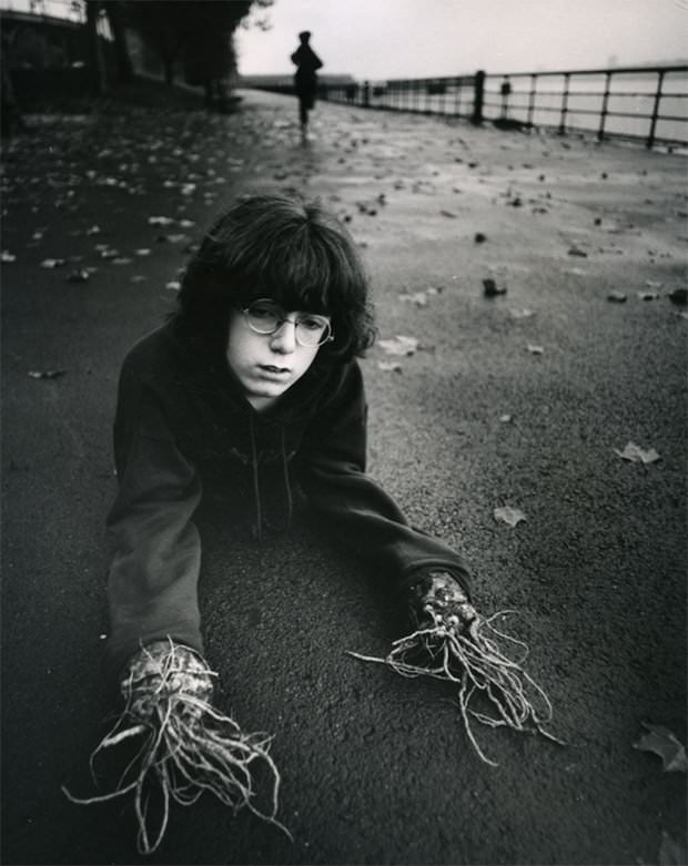 A child with roots for hands as part of a picture set of "Childrens Dreams" in the US by Arthur Tress in 1965.