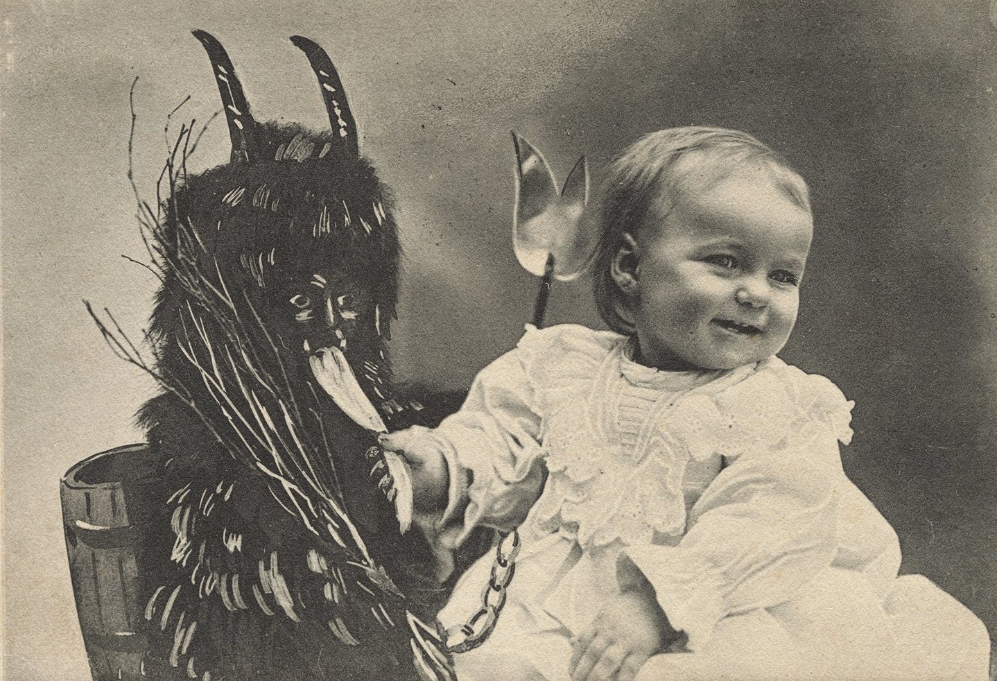 A child posing with a version of Krampus in Vienna, Austria in 1909.