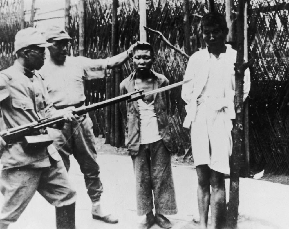 2 Men posed by the Japanese before their execution during the Nanking Massacre in China in 1937.