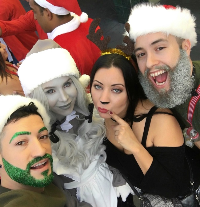 A girl wearing a black and white Santa costume