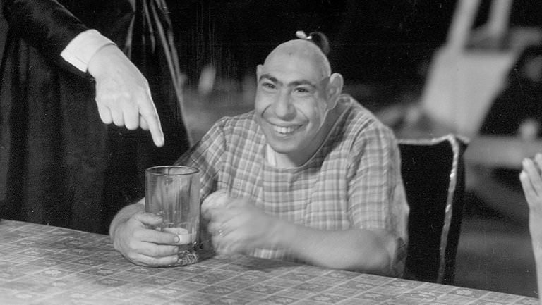 Pinhead (Real name Schlitzie).

Schlitzie was born microcephalus, a condition characterised by an abnormally small and often pointed cranium. The condition often resulted in retardation and Schlitzie himself was as cognitive as a four year old. Previous to Schlitzie, the display and exhibiting of ‘pinheads’ was nothing new. In the 1800’s pinheads were often exhibited as a species apart from man, as the last members of an ancient race – usually Aztecs – and on occasion they were billed as being from another planet. During his lifetime, Schlitzie was exhibited as all of these things. Schlitzie was most famously preceded by the pinhead Zip, and even today pinheads enjoy popularity as a microcephalus man dubbed Beetlejuice frequents The Howard Stern Show.