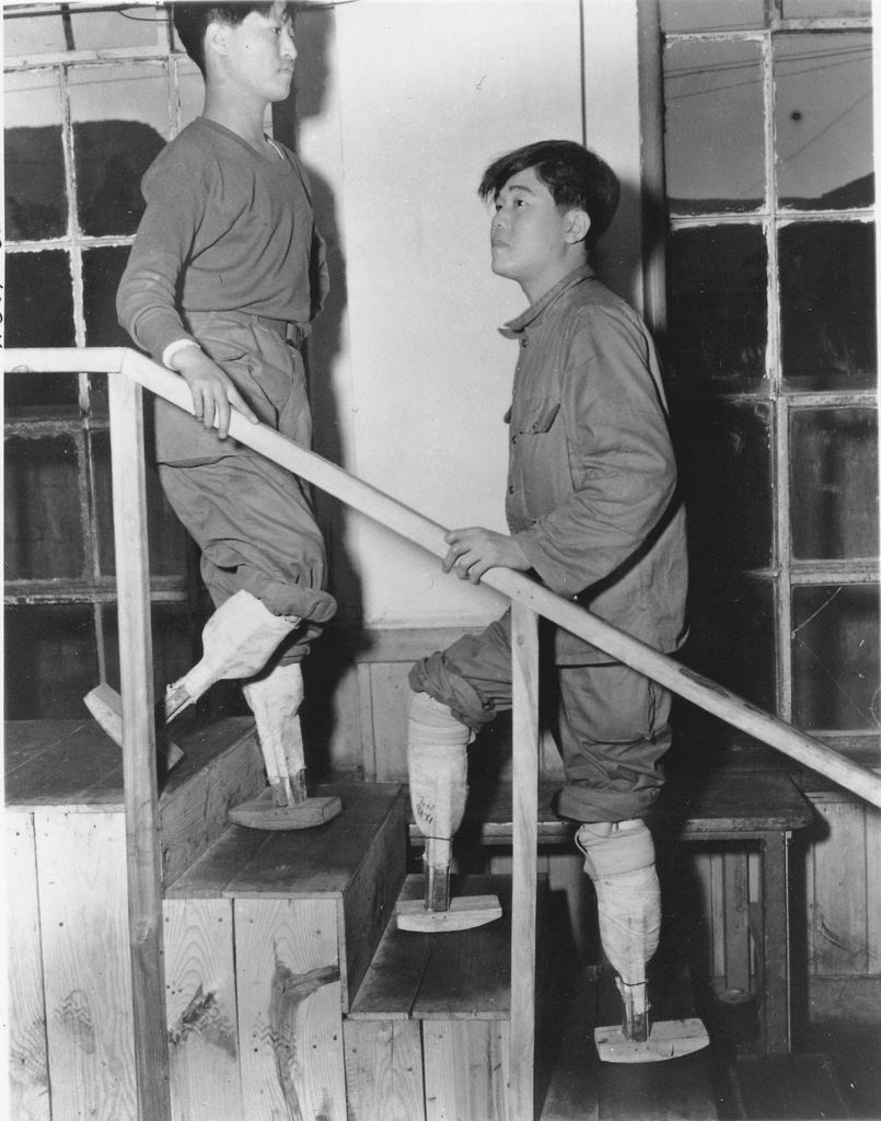 Double amputees and veterans of the Korean War demonstrate experimental prosthetic legs in South Korean in 1955.