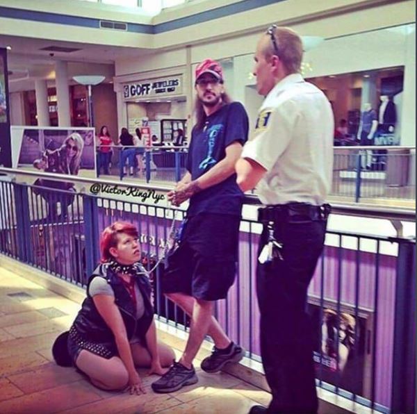 trashy couple with the woman acting like a dog being stopped by mall cop