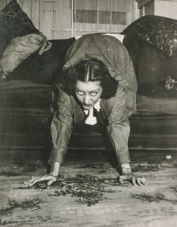A woman crawling off her couch in the US in the 1940s.
