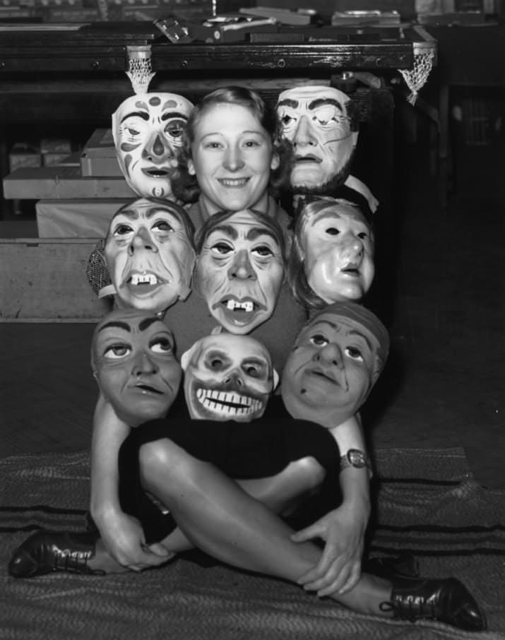 A woman shows off some masks in the US in 1953.