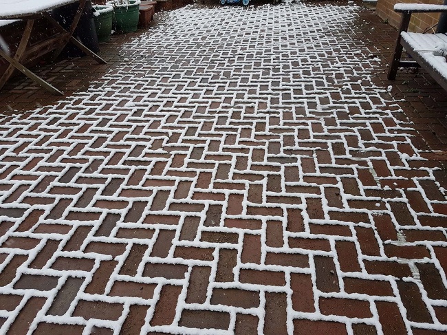 The snow settled only on the outline of the bricks in my friends driveway.