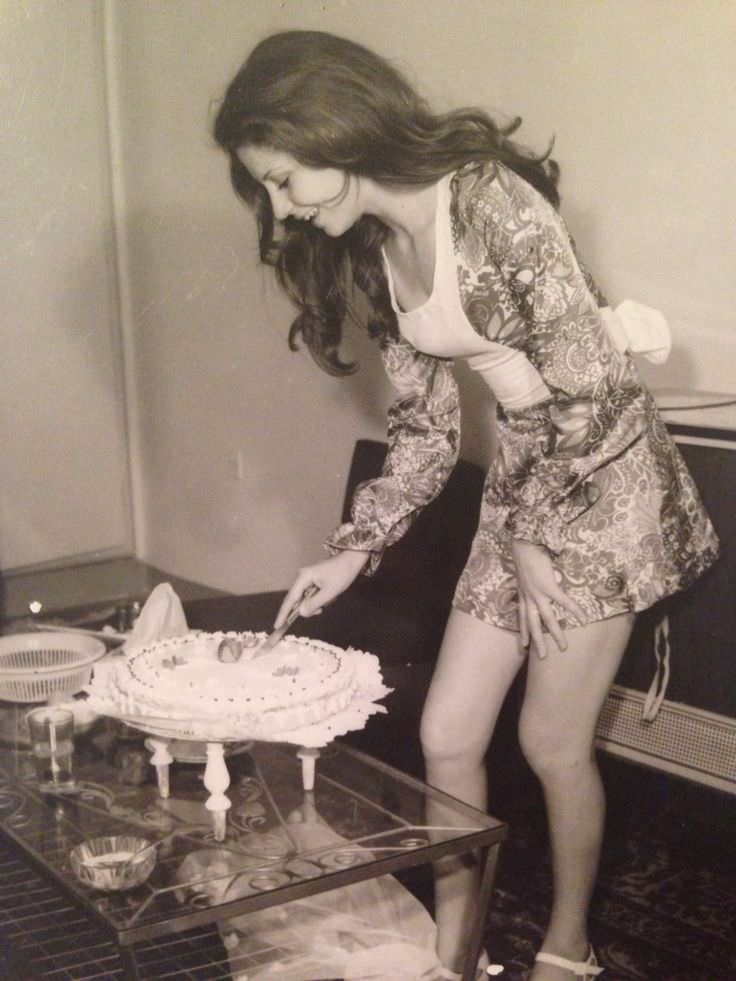 A woman cutting cake at her birthday party in Tehran, Iran in 1973.