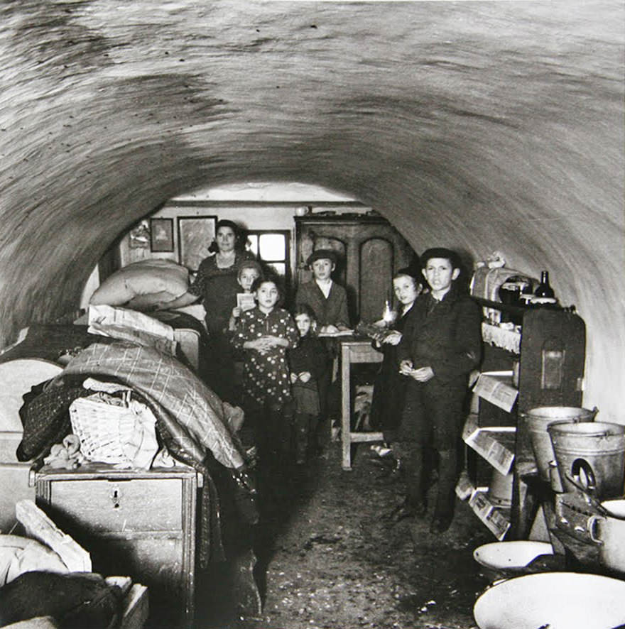 A family in a basement dwelling in Warsaw, Poland in 1937.