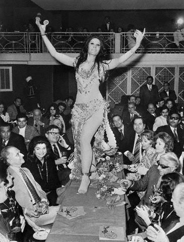 Egyptian belly dancer Zizi Mostafa dancing for former first lady Mrs. Jacqueline 'Kennedy' Onassis (in black, left) and her then husband Aristotle Onassis in Cairo, Egypt in 1974.