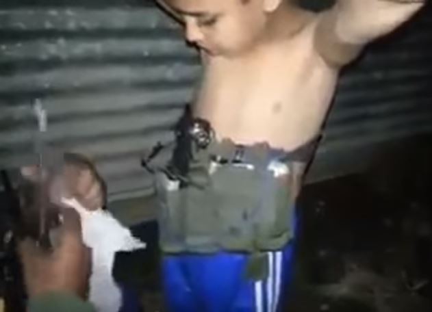 Iraqi soldier removes suicide belt from boy in Mosul