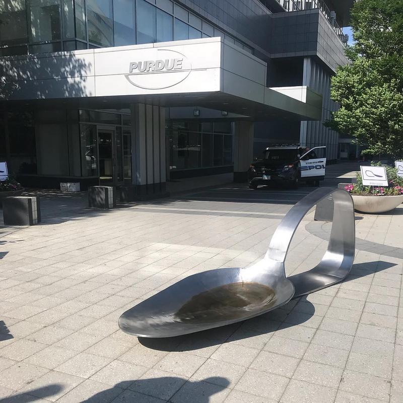 A giant bent and burned spoon sculpture was placed on Purdue (Oxycontin) drug makers doorstep