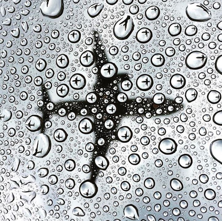 A photograph of a plane through drops of water