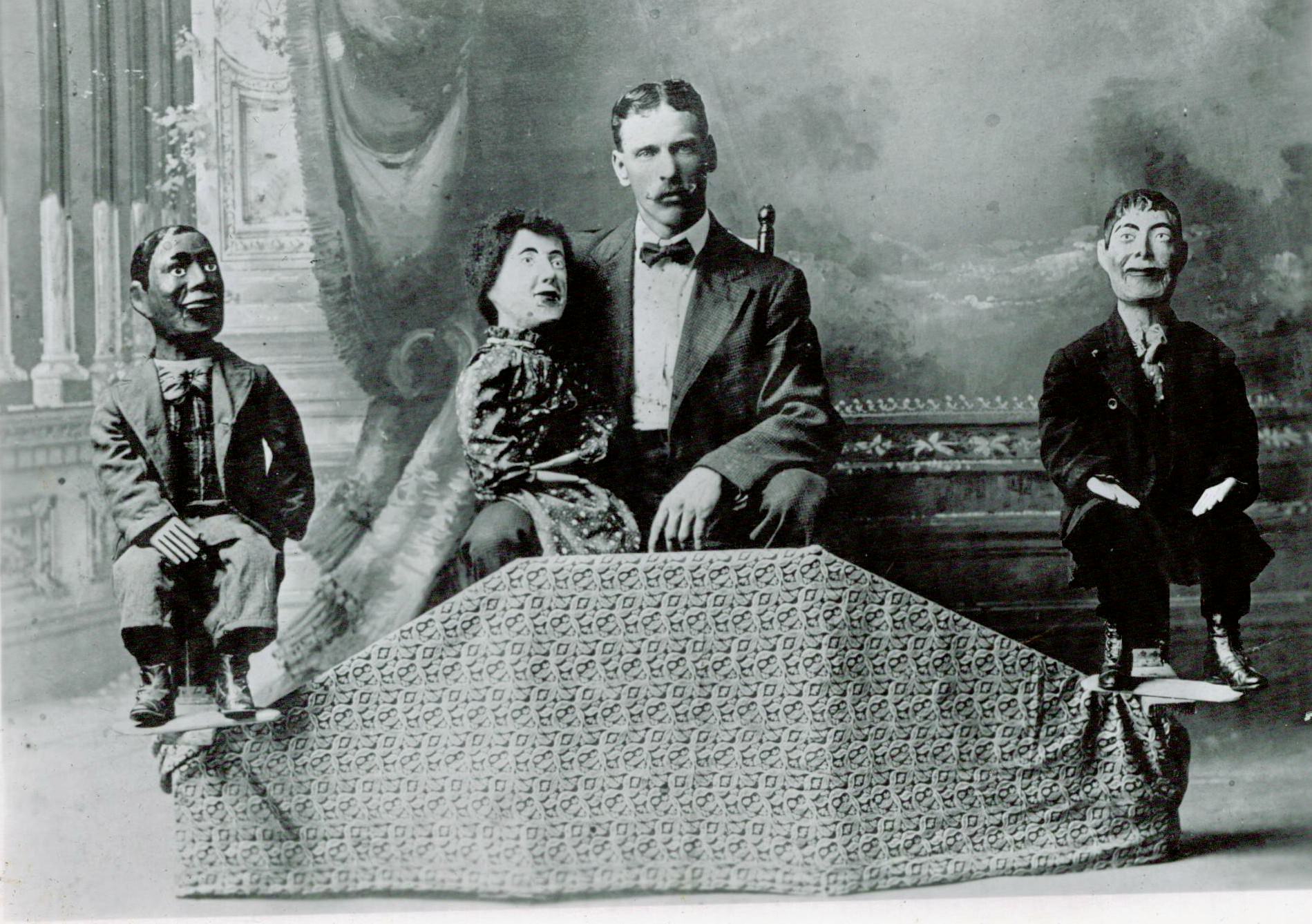 A man poses with his dummies in England in 1888.