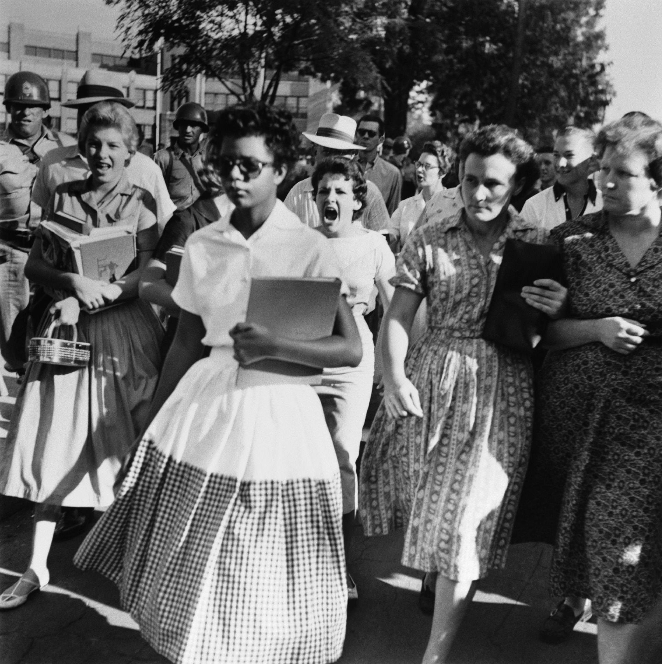 Elizabeth Ann Eckford, one of the 9 black students who desegregated Little Rock Central High School, being heckled by other school girls and their mothers as she heads into school in Arkansas, US in 1957.