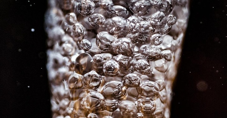 A stream of water pouring from a faucet captured at 1/25th of a second