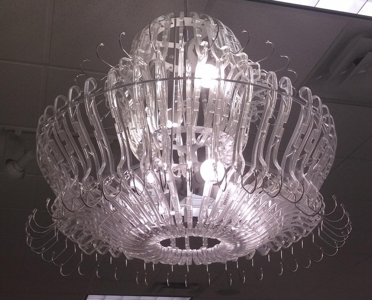 This chandelier at a clothing store is made of clothes hangers.