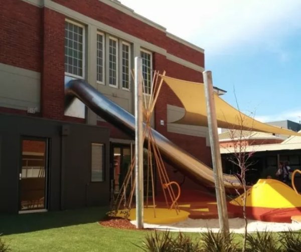 A school that has a slide from a classroom directly to the playground, because efficiency is key.