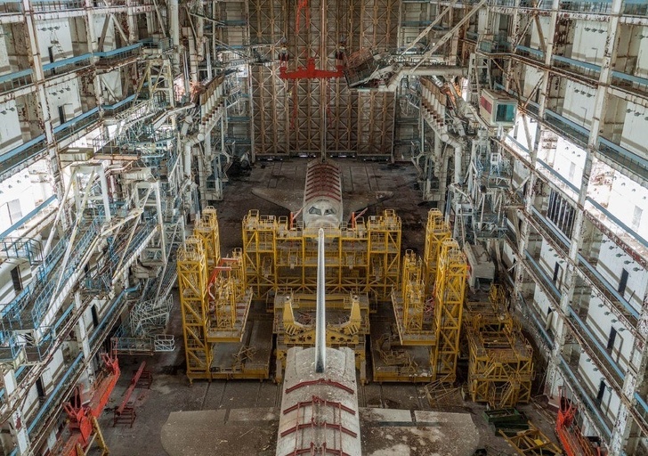 The inside of an abandoned spacecraft hangar.
