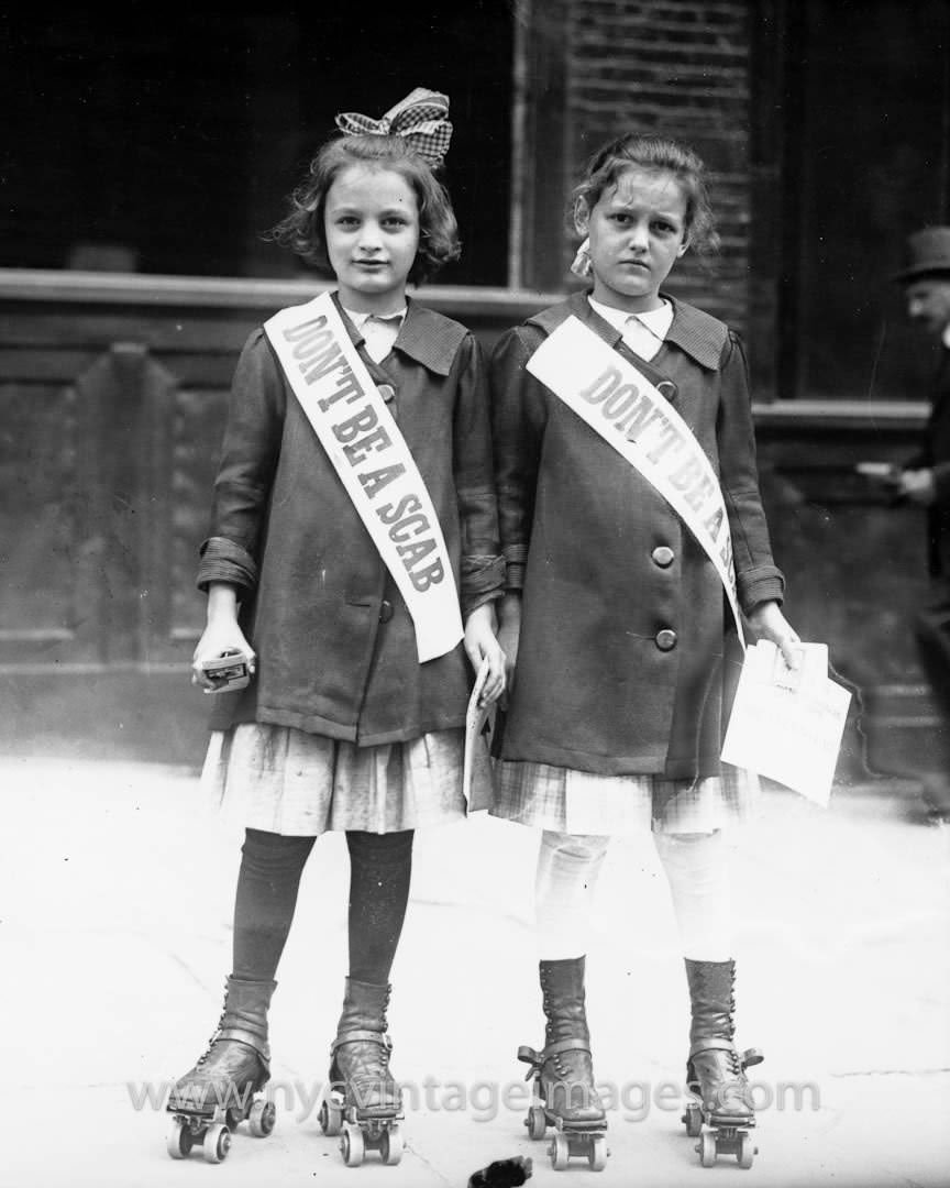 2 Girls on roller skates wearing "Don't Be a Scab" sashes in NYC, US in 1916. A scab was a person who was kept working under previous conditions while the majority of workers were on strike.