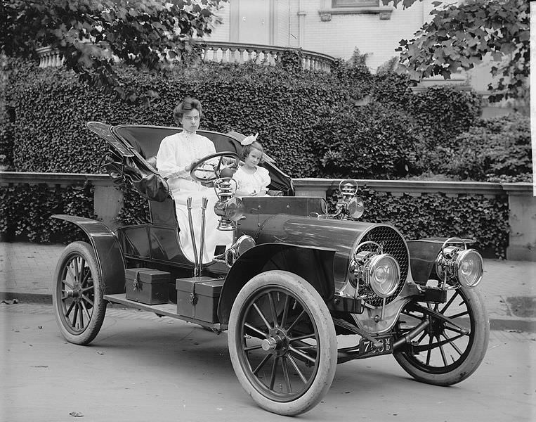 Car maker Franklin Bliven takes a picture of his wife and daughter in a Franklin Model D roadster in the US in 1908.