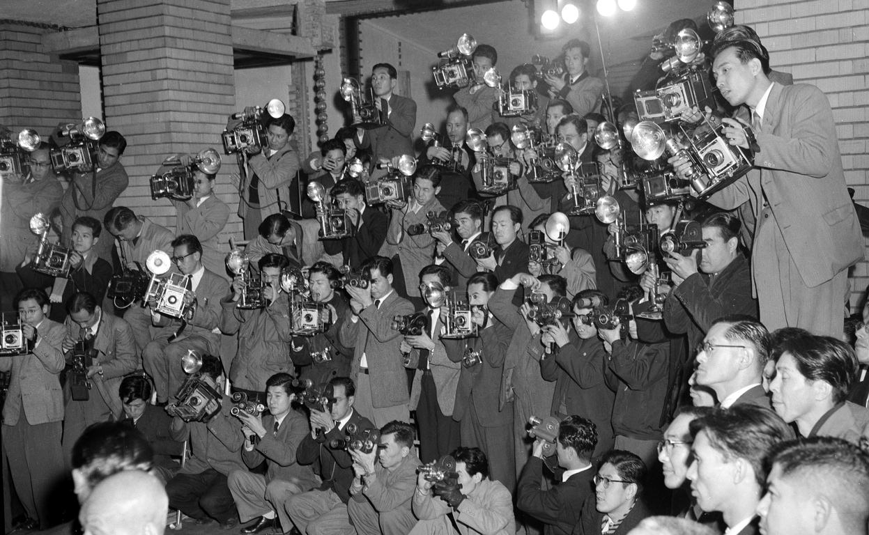 Forty-five cameramen photograph the new Japanese cabinet at the Prime Minister's official residence in downtown Tokyo, Japan in 1954. Japanese newspapers usually sent 3 or 4 photographers to cover an event from all possible angles.