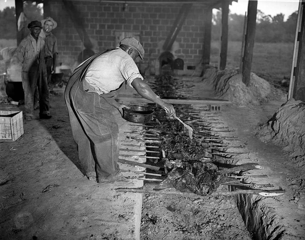 A man prepares Southern BBQ in Alabama, US in 1932.