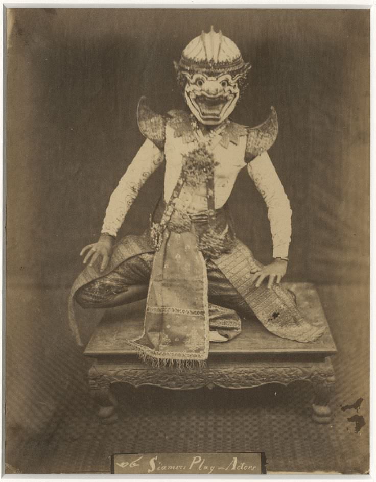 An actor wears his costume and mask in Siam (Thailand) in 1900.