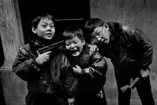Kids playing with fake guns in Shanghai, China in 1995.