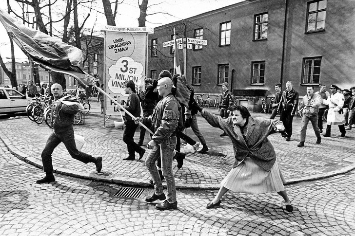 woman hitting a neo-nazi with her handbag