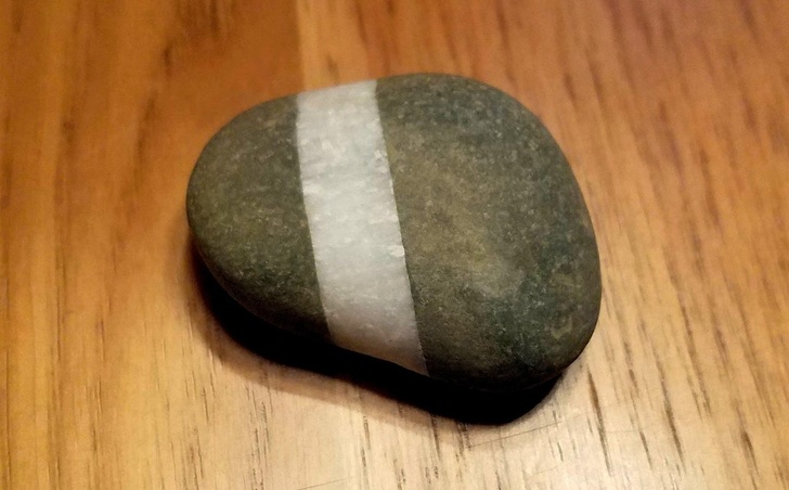 This rock has a perfect quartz stripe.
