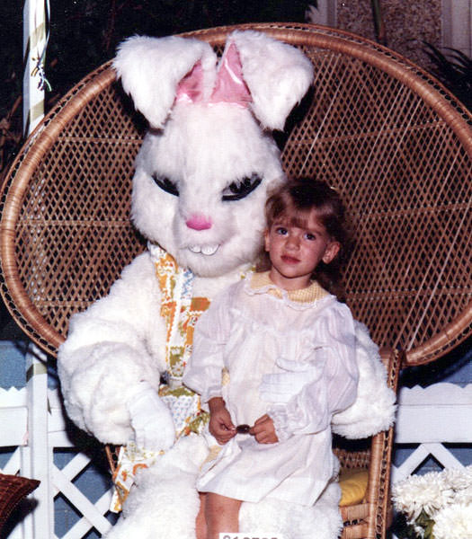 A kid sits on a creepy Easter bunny in the US in 1984.