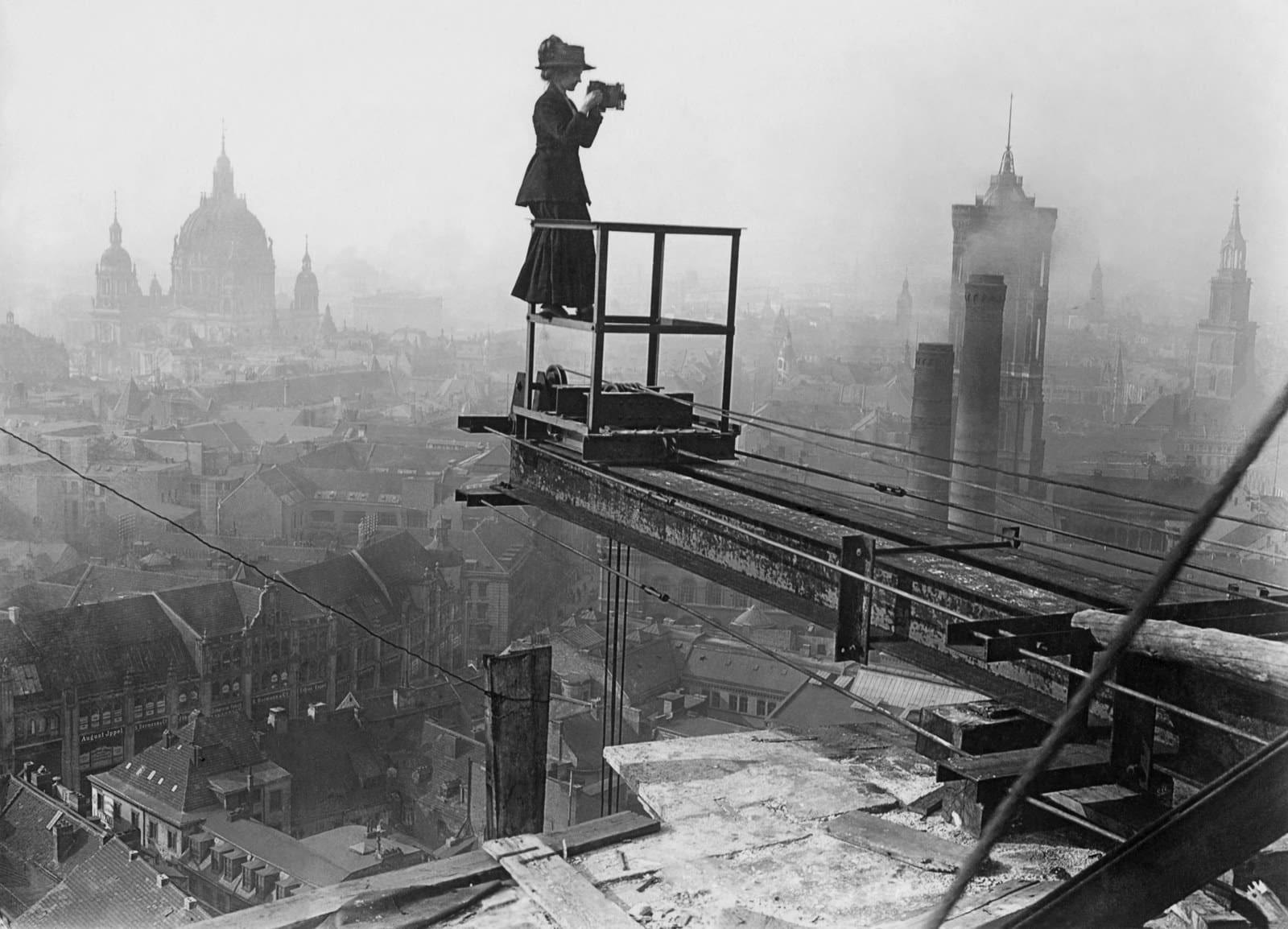 A female photographer takes a difficult and dangerous picture surveying Berlin, Germany in 1910.