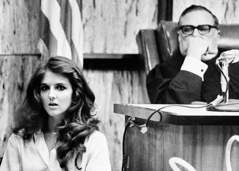 Carol DaRonch, one of the only women to escape Ted Bundy during his 4 year serial killing spree, takes the stand and freezes for a moment while looking at her potential murderer during his trial in 1976. She was only 18 when she barely escaped him 2 years prior.