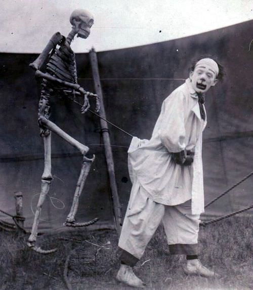 A clown using a skeleton for a prop in a circus in France in 1923.
