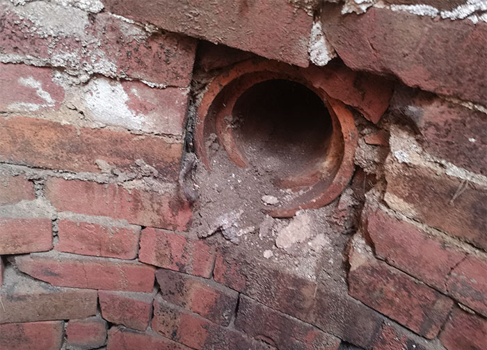 “A pipe seemingly going to the chamber from the direction of the house”